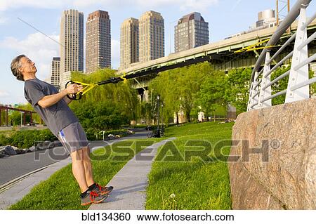 Caucasian man exercising in urban park View Large Photo Image Stock Image - Caucasian man exercising in urban park. Fotosearch