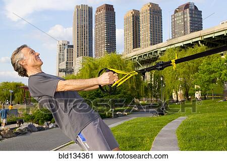 Caucasian man exercising in urban park View Large Photo Image Stock Image - Caucasian man exercising in urban park. Fotosearch
