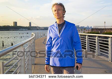 Caucasian man standing at urban waterfront View Large Photo Image Stock Image - Caucasian man standing at urban waterfront. Fotosearch