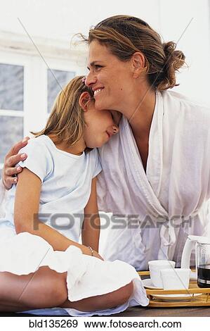 Stock Photo - Caucasian mother and daughter hugging. Fotosearch