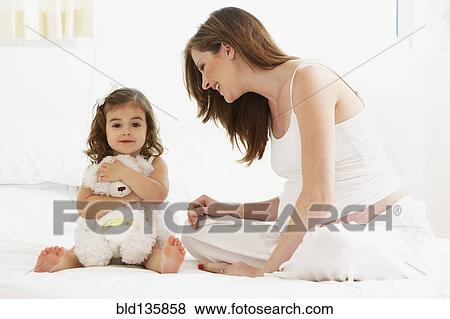 Caucasian mother and daughter playing with teddy bear View Large Photo Image Stock Photo - Caucasian mother and daughter playing with teddy bear. Fotosearch