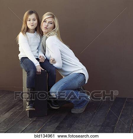 Caucasian mother and daughter smiling together View Large Photo Image Stock Image - Caucasian mother and daughter smiling together. Fotosearch