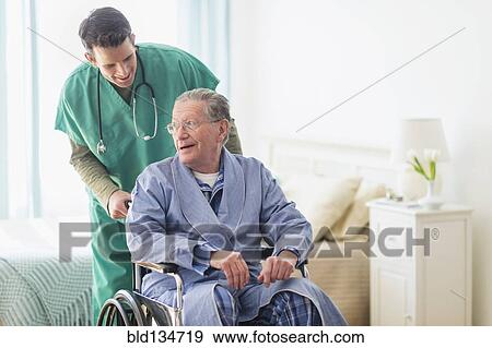 Caucasian nurse wheeling patient in home View Large Photo Image Stock Photo - Caucasian nurse wheeling patient in home. Fotosearch