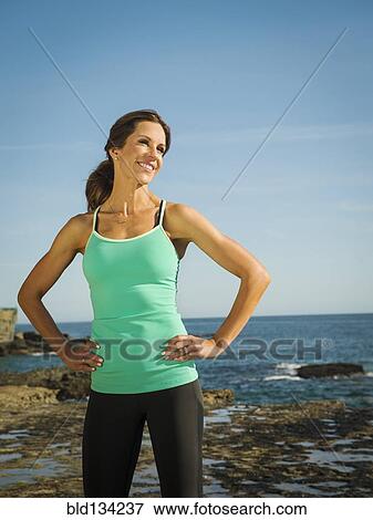 Stock Photo - Caucasian runner smiling on beach. Fotosearch