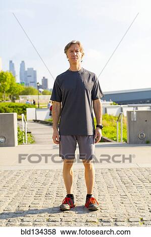Caucasian runner standing in urban park View Large Photo Image Stock Photo - Caucasian runner standing in urban park. Fotosearch