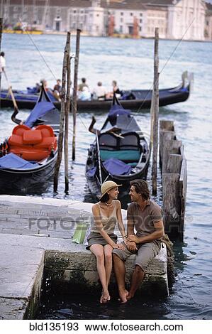 Caucasian sitting together by canal, Venice, Veneto, Italy View Large Photo Image Stock Image - Caucasian sitting together by canal, Venice, Veneto, Italy. Fotosearch
