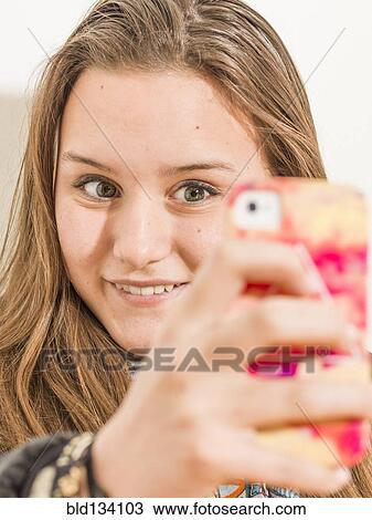 Caucasian teenage girl taking picture with cell phone View Large Photo Image Stock Image - Caucasian teenage girl taking picture with cell phone. Fotosearch