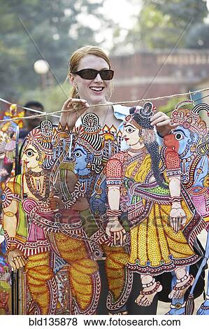 Caucasian woman admiring traditional art in outdoor market View Large Photo Image Stock Photo - Caucasian woman admiring traditional art in outdoor market. Fotosearch