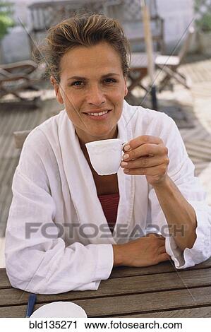 Caucasian woman drinking coffee outdoors View Large Photo Image Stock Image - Caucasian woman drinking coffee outdoors. Fotosearch