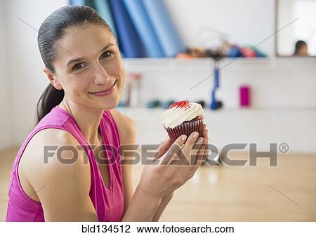 Caucasian woman holding cupcake View Large Photo Image Stock Image - Caucasian woman holding cupcake. Fotosearch