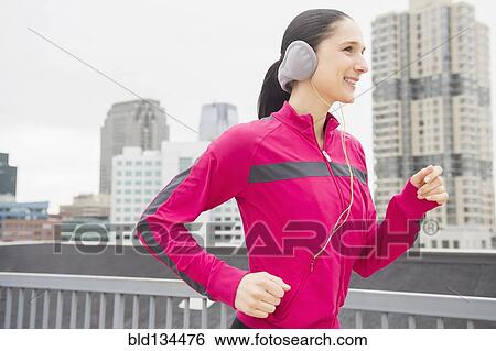 Caucasian woman jogging in city View Large Photo Image Stock Photograph - Caucasian woman jogging in city. Fotosearch