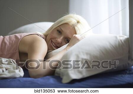 Caucasian woman laying in bed View Large Photo Image Stock Image - Caucasian woman laying in bed. Fotosearch
