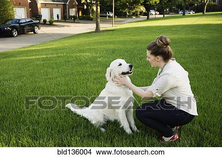 Caucasian woman petting dog in park View Large Photo Image Picture - Caucasian woman petting dog in park. Fotosearch