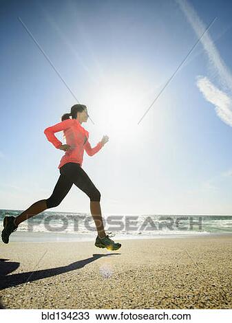 Caucasian woman running on beach View Large Photo Image Stock Image - Caucasian woman running on beach. Fotosearch