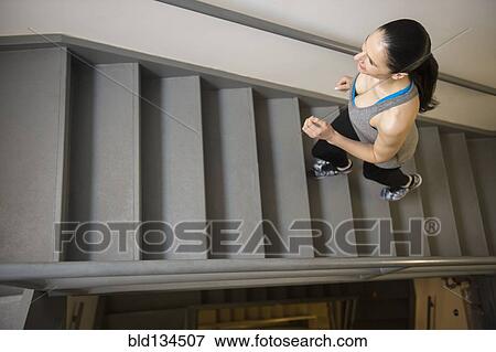 Caucasian woman running up stairs View Large Photo Image Stock Photo - Caucasian woman running up stairs. Fotosearch