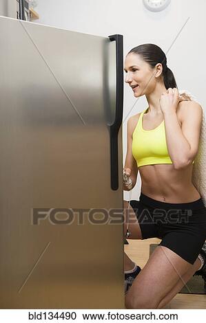 Caucasian woman searching refrigerator for food View Large Photo Image Stock Image - Caucasian woman searching refrigerator for food. Fotosearch
