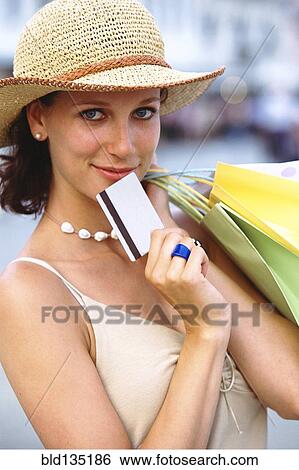 Stock Photograph - Caucasian woman shopping on city street. Fotosearch