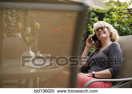 Caucasian woman talking on cell phone outdoors View Large Photo Image Stock Photography - Caucasian woman talking on cell phone outdoors. Fotosearch