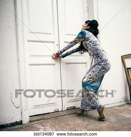 Caucasian woman trying to open locked door View Large Photo Image Stock Photo - Caucasian woman trying to open locked door. Fotosearch