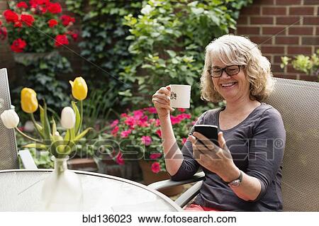 Caucasian woman using cell phone outdoors View Large Photo Image Stock Image - Caucasian woman using cell phone outdoors. Fotosearch