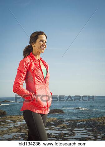 Caucasian woman walking on beach View Large Photo Image Stock Photograph - Caucasian woman walking on beach. Fotosearch