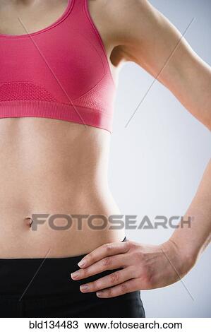 Caucasian woman with bare stomach wearing sports clothing View Large Photo Image Stock Image - Caucasian woman with bare stomach wearing sports clothing. Fotosearch