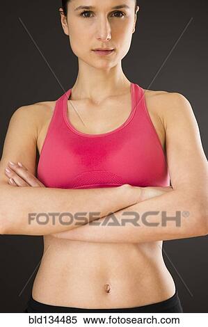 Stock Photography - Caucasian woman with bare stomach wearing sports clothing. Fotosearch
