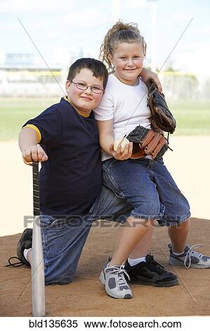 Children smiling together on baseball diamond View Large Photo Image Stock Photography - Children smiling together on baseball diamond. Fotosearch