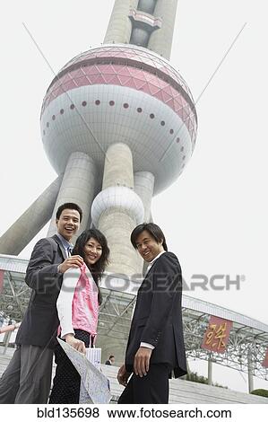 Stock Photo - Chinese business people under Oriental Pearl Tower, Shanghai, China. Fotosearch