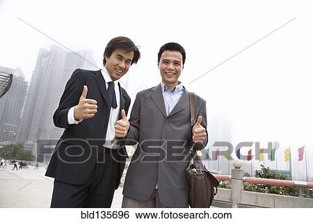 Chinese businessmen giving 'thumbs up' on city street, Shanghai, China View Large Photo Image Stock Photograph - Chinese businessmen giving 'thumbs up' on city street, Shanghai, China. Fotosearch