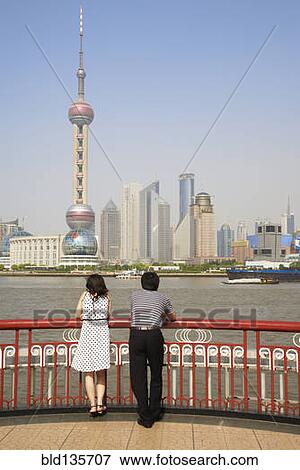Chinese couple looking at city skyline, Shanghai, China View Large Photo Image Stock Photo - Chinese couple looking at city skyline, Shanghai, China. Fotosearch