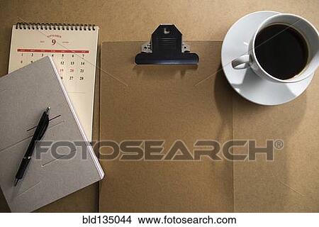 Clipboard and notepad with coffee on table View Large Photo Image Picture - Clipboard and notepad with coffee on table. Fotosearch