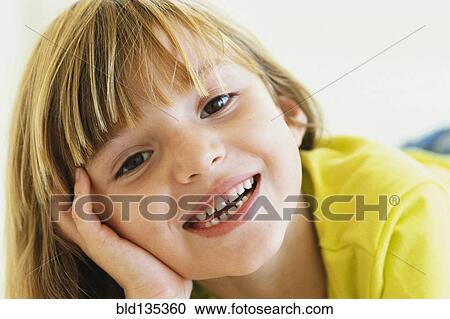 Stock Image - Close up of girl's smiling face. Fotosearch