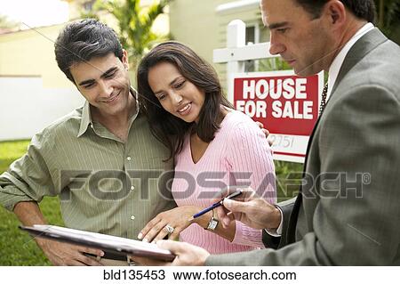 Couple and realtor signing papers for new house View Large Photo Image Stock Image - Couple and realtor signing papers for new house. Fotosearch