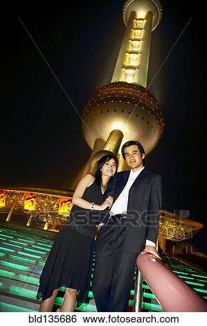 Couple below Oriental Pearl Tower at night, Shanghai, China View Large Photo Image Stock Photograph - Couple below Oriental Pearl Tower at night, Shanghai, China. Fotosearch