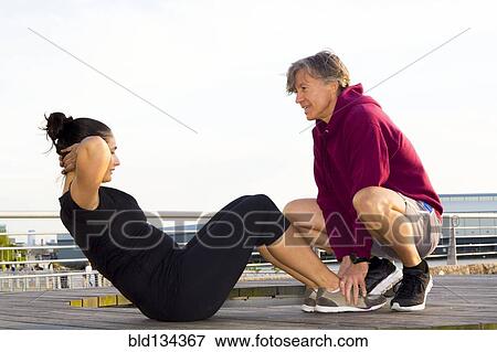 Couple exercising in waterfront park View Large Photo Image Stock Photo - Couple exercising in waterfront park. Fotosearch