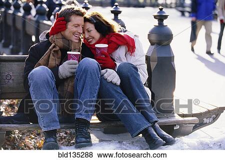 Couple having coffee in urban park View Large Photo Image Stock Photo - Couple having coffee in urban park. Fotosearch
