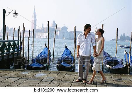 Couple holding hands on urban canal front, Venice, Veneto, Italy View Large Photo Image Stock Image - Couple holding hands on urban canal front, Venice, Veneto, Italy. Fotosearch