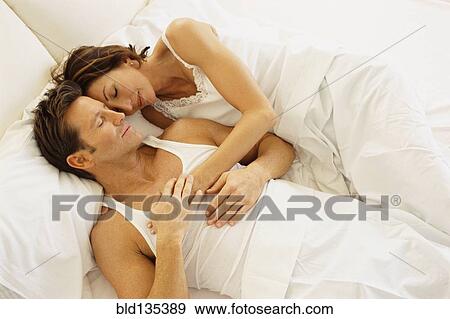 Couple hugging in bed View Large Photo Image Stock Photo - Couple hugging in bed. Fotosearch