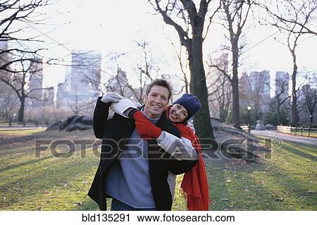 Stock Image - Couple hugging in Central Park, New York City, New York, United States. Fotosearch