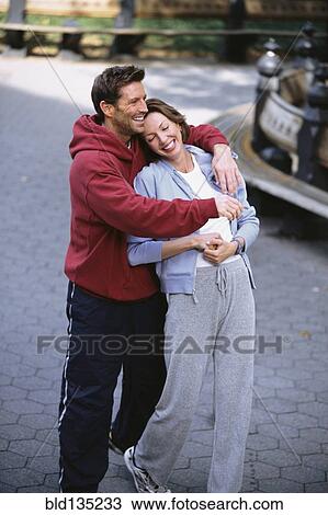 Couple hugging in urban park View Large Photo Image Stock Image - Couple hugging in urban park. Fotosearch