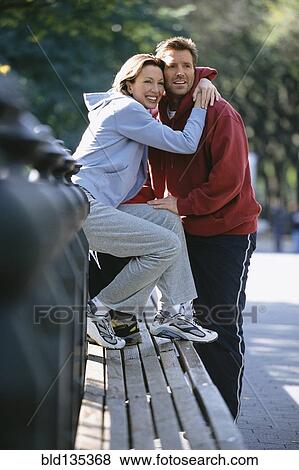 Couple hugging in urban park View Large Photo Image Stock Photo - Couple hugging in urban park. Fotosearch