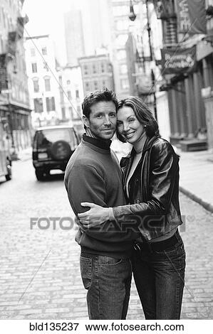 Stock Photo - Couple hugging on city street. Fotosearch