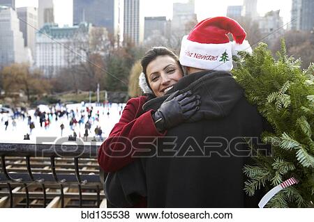 Couple hugging on city street View Large Photo Image Stock Photo - Couple hugging on city street. Fotosearch