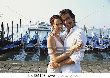 Stock Photo - Couple hugging on urban canal front, Venice, Veneto, Italy. Fotosearch