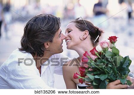 Couple kissing outdoors View Large Photo Image Stock Photograph - Couple kissing outdoors. Fotosearch