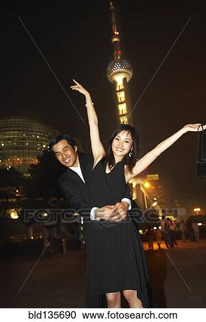 Couple outside Oriental Pearl Tower at night, Shanghai, China View Large Photo Image Stock Image - Couple outside Oriental Pearl Tower at night, Shanghai, China. Fotosearch