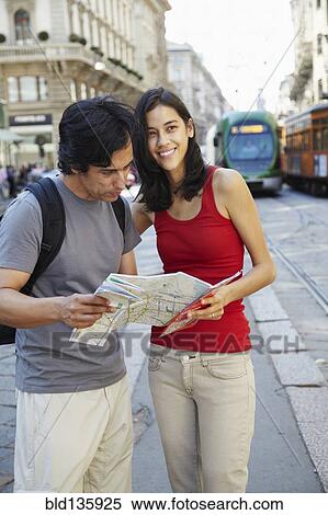 Couple reading map on city street View Large Photo Image Stock Photography - Couple reading map on city street. Fotosearch