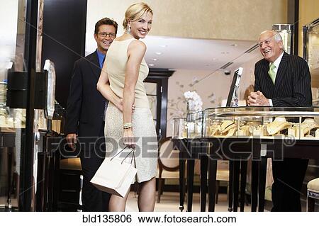 Couple shopping in jewelry store View Large Photo Image Stock Photograph - Couple shopping in jewelry store. Fotosearch