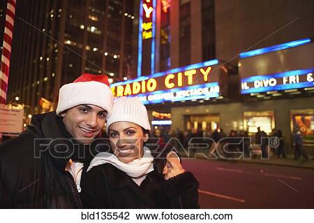 Couple smiling outside Radio City Hall, New York, New York, United States View Large Photo Image Stock Image - Couple smiling outside Radio City Hall, New York, New York, United States. Fotosearch